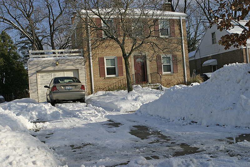 Several snows piled up in the driveway; deep white (icy) Xmas