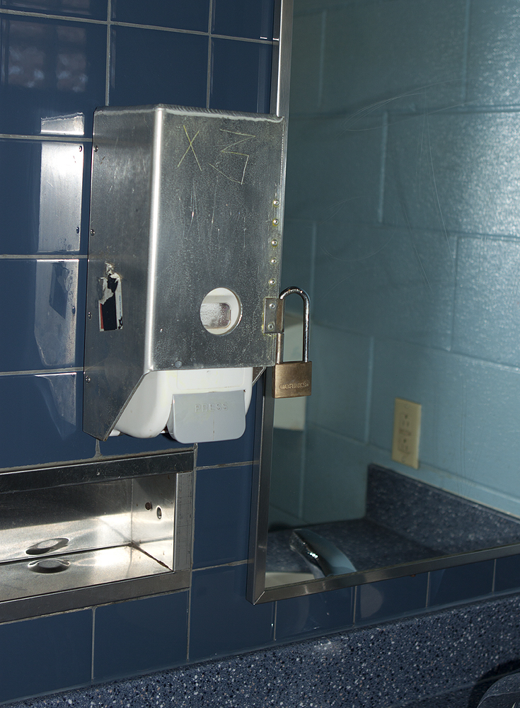 Lock on public washroom soap dispenser